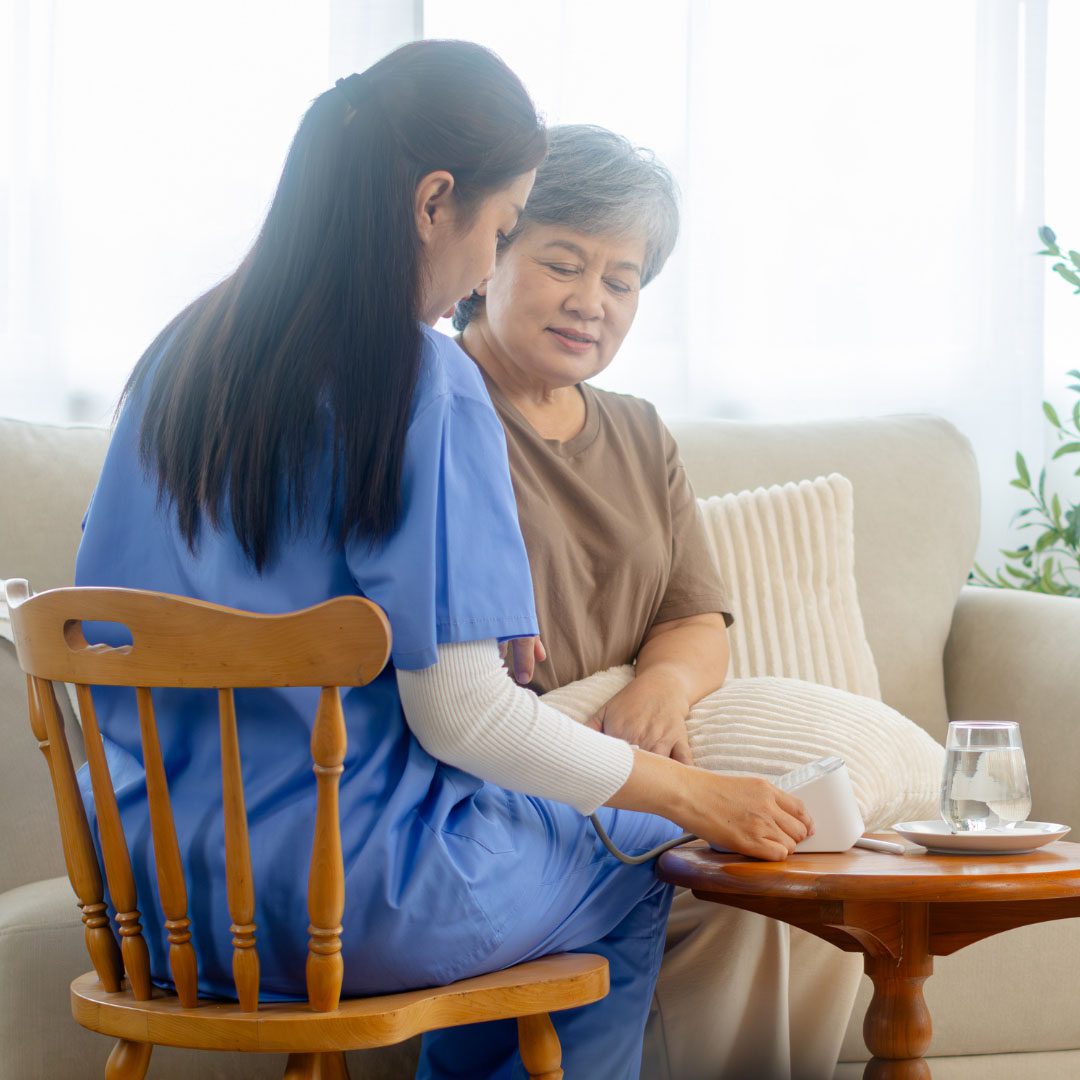Elderly woman receiving care from a female nurse at home
